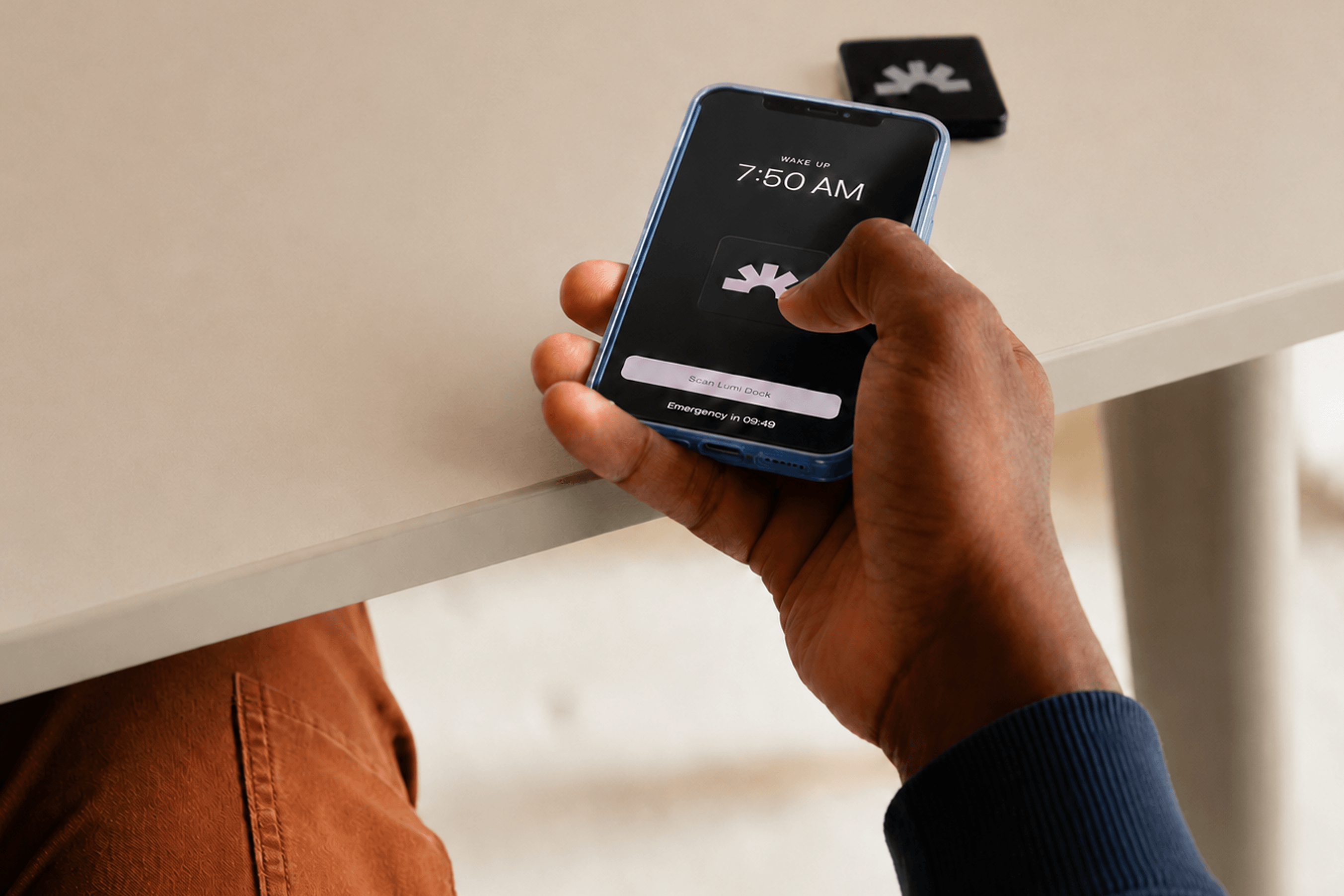 Person scanning a Lumi Dock to dismiss a wake-up alarm
